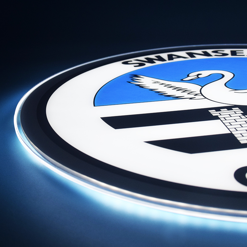 Close-up of the UV printed Swansea City crest while lit