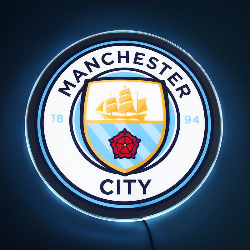 Manchester City LED light-up panel glowing on a dark wall