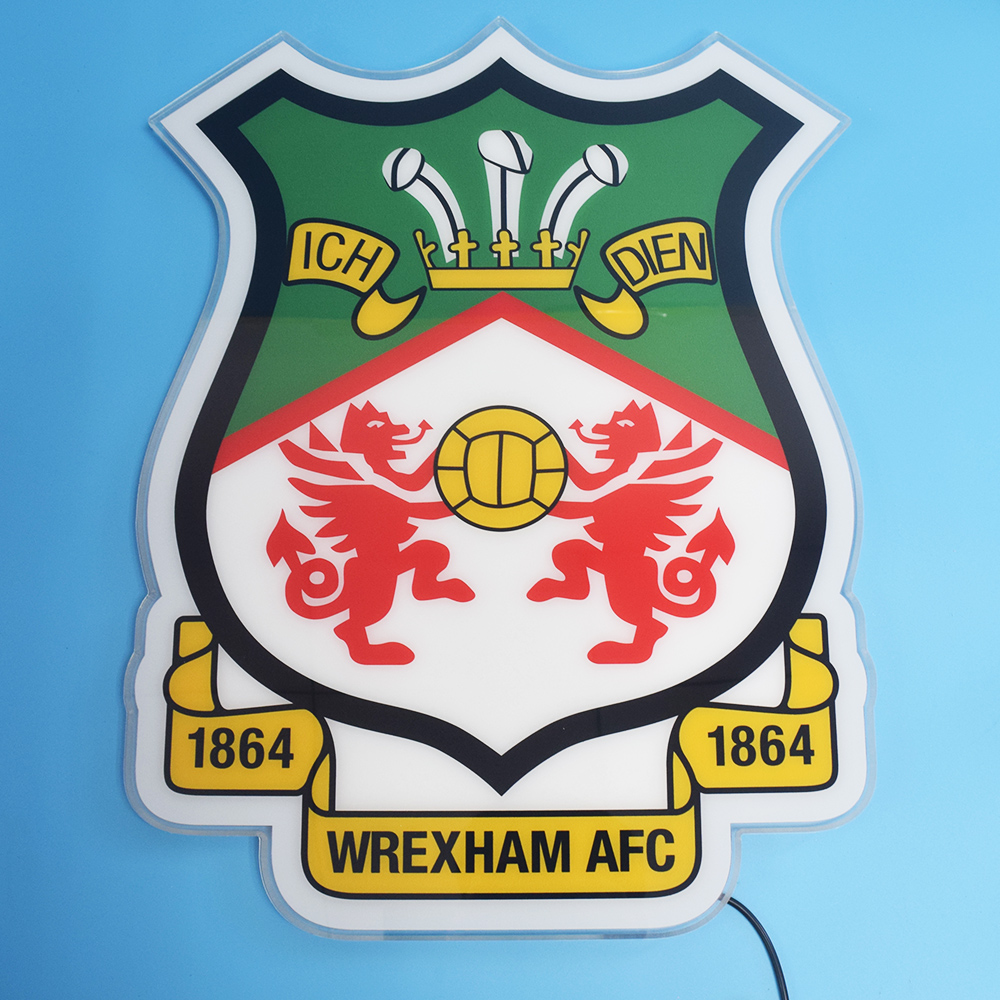 Unlit Wrexham AFC acrylic panel on a blue wall