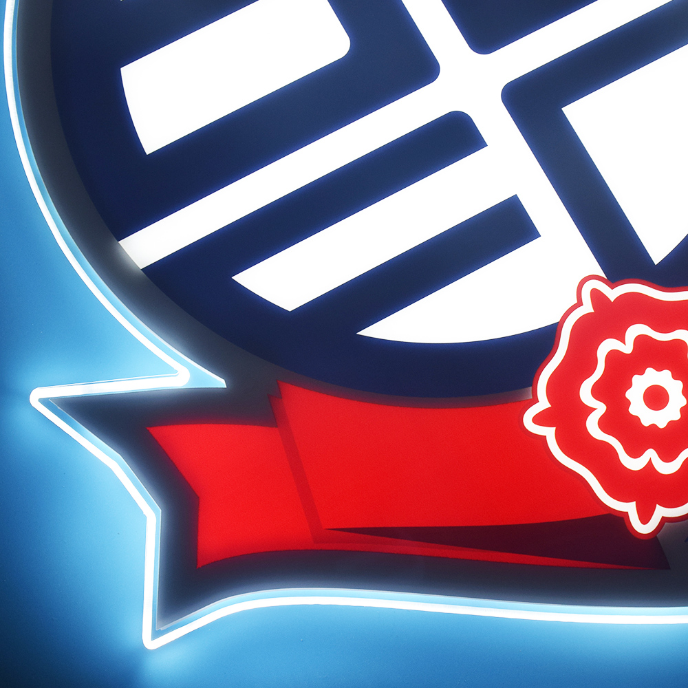 Close-up of the lit Bolton Wanderers crest detail