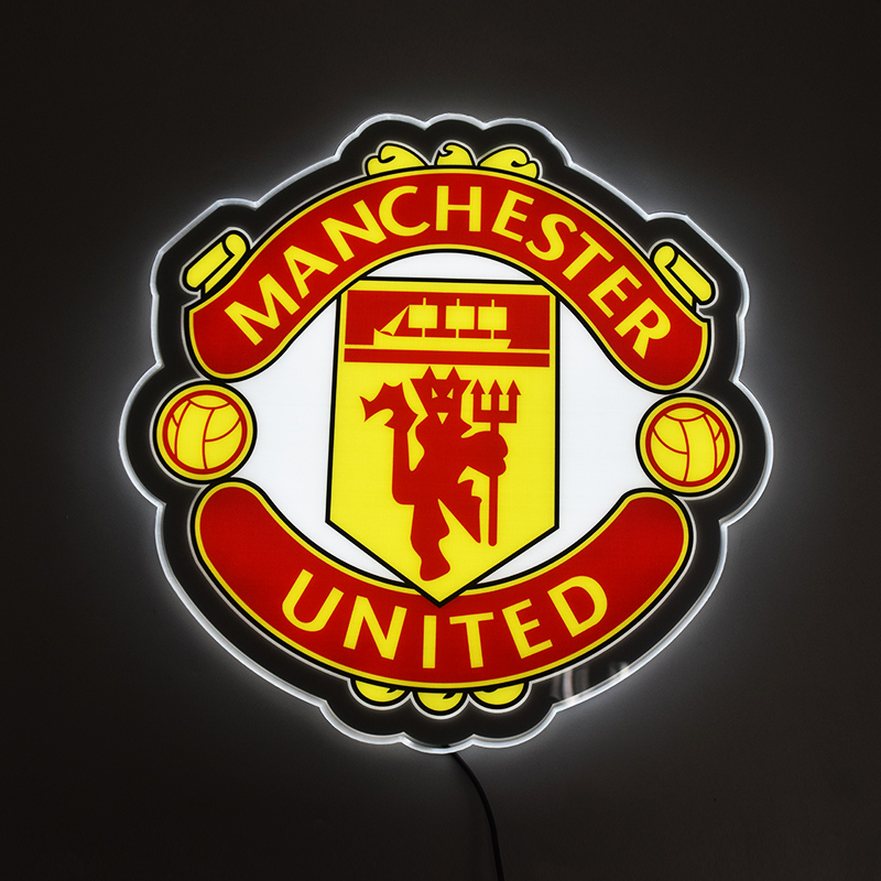 Manchester United crest LED light-up panel glowing on a dark wall