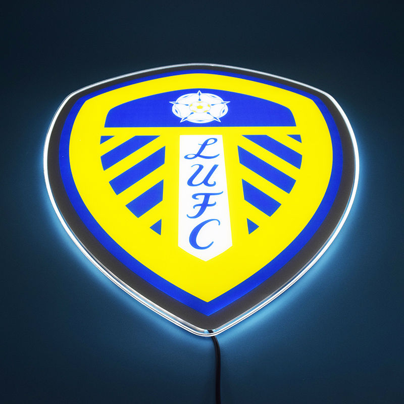 Leeds United crest LED light-up panel glowing head-on in a dark room