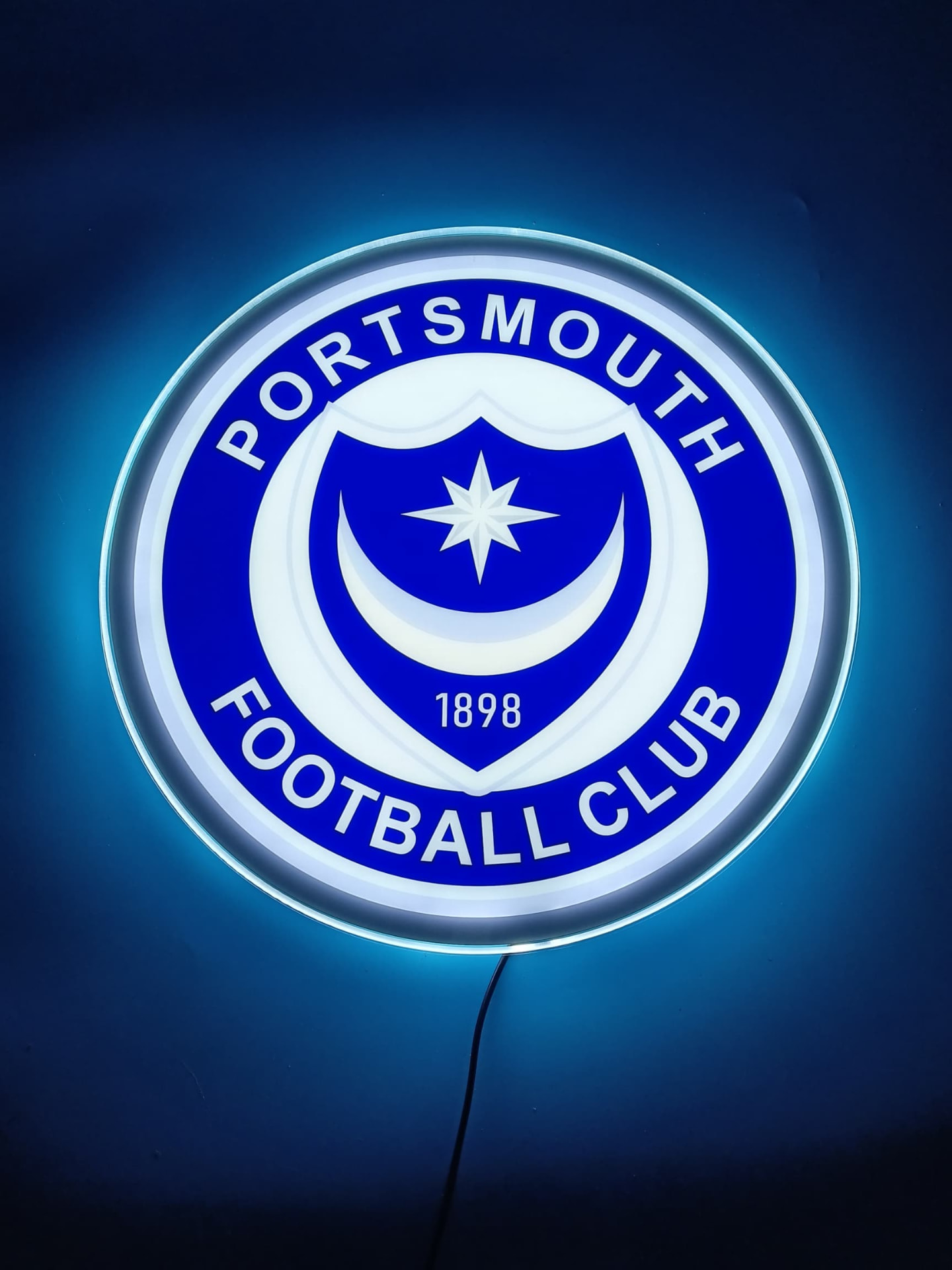 Portsmouth FC LED light-up panel glowing on a dark wall